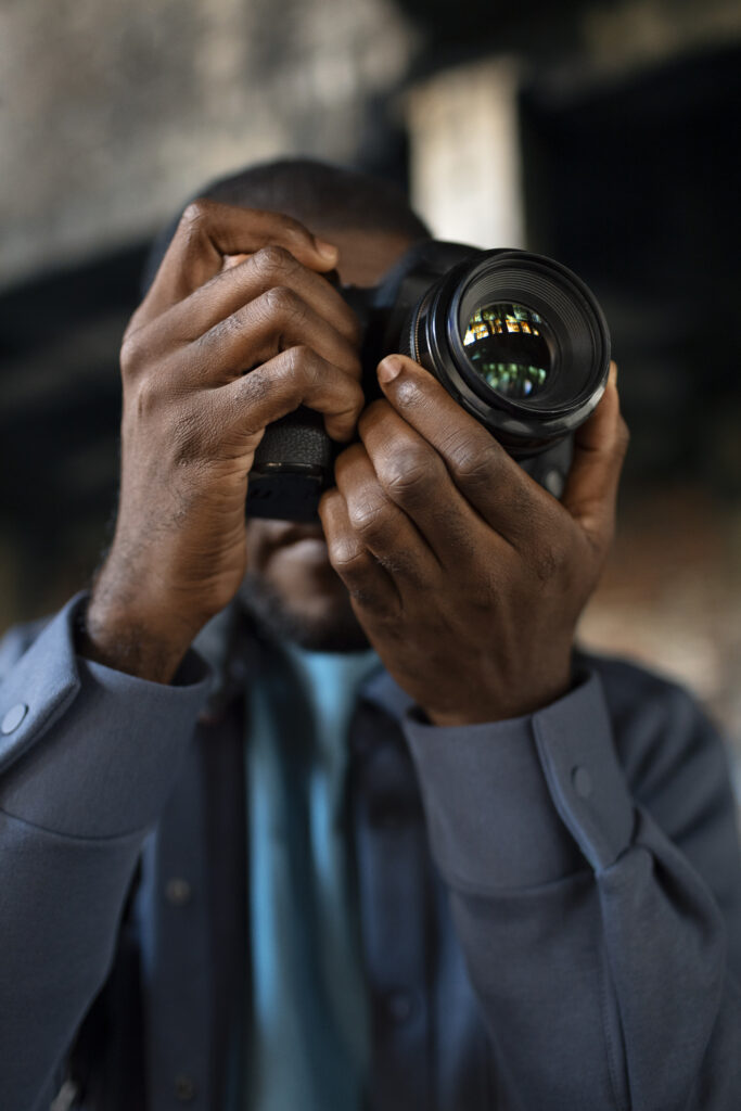 male photographer exploring urban environment with grunge aesthetic